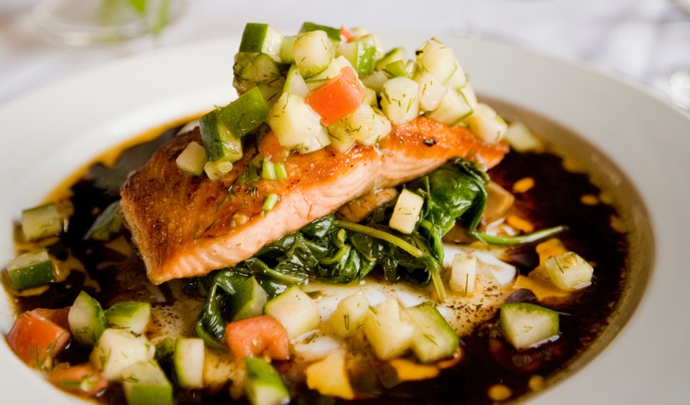 Seared Salmon in a bowl of broth and vegetables